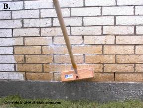 Using brush to clean brick.